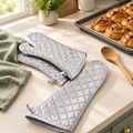 Extra-long silver oven mitts in a warm baking scene
